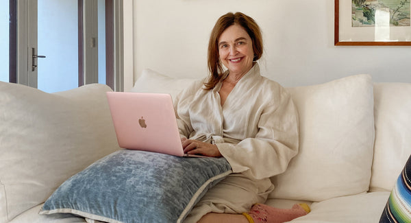 A Woman In A Robe On Her Laptop