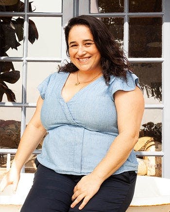 Woman Smiling In Front Of A Window