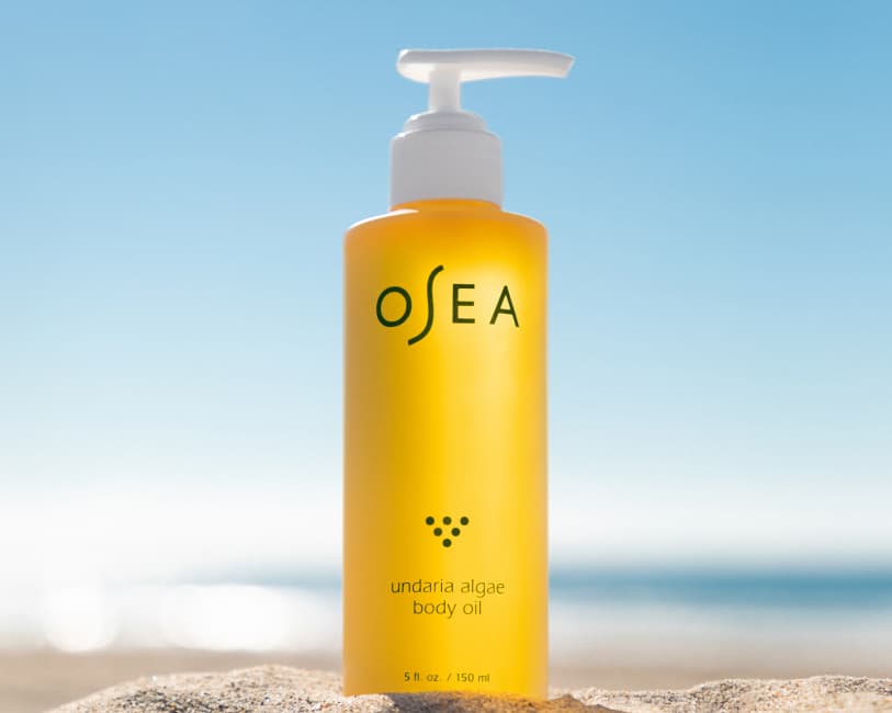 Undaria Body Oil standing on a beach