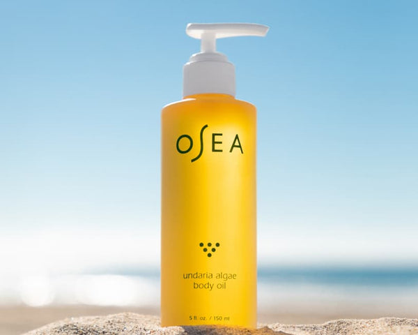 Undaria Body Oil standing on a beach